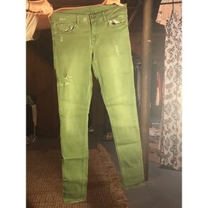 Lightly distressed army green skinny jeans